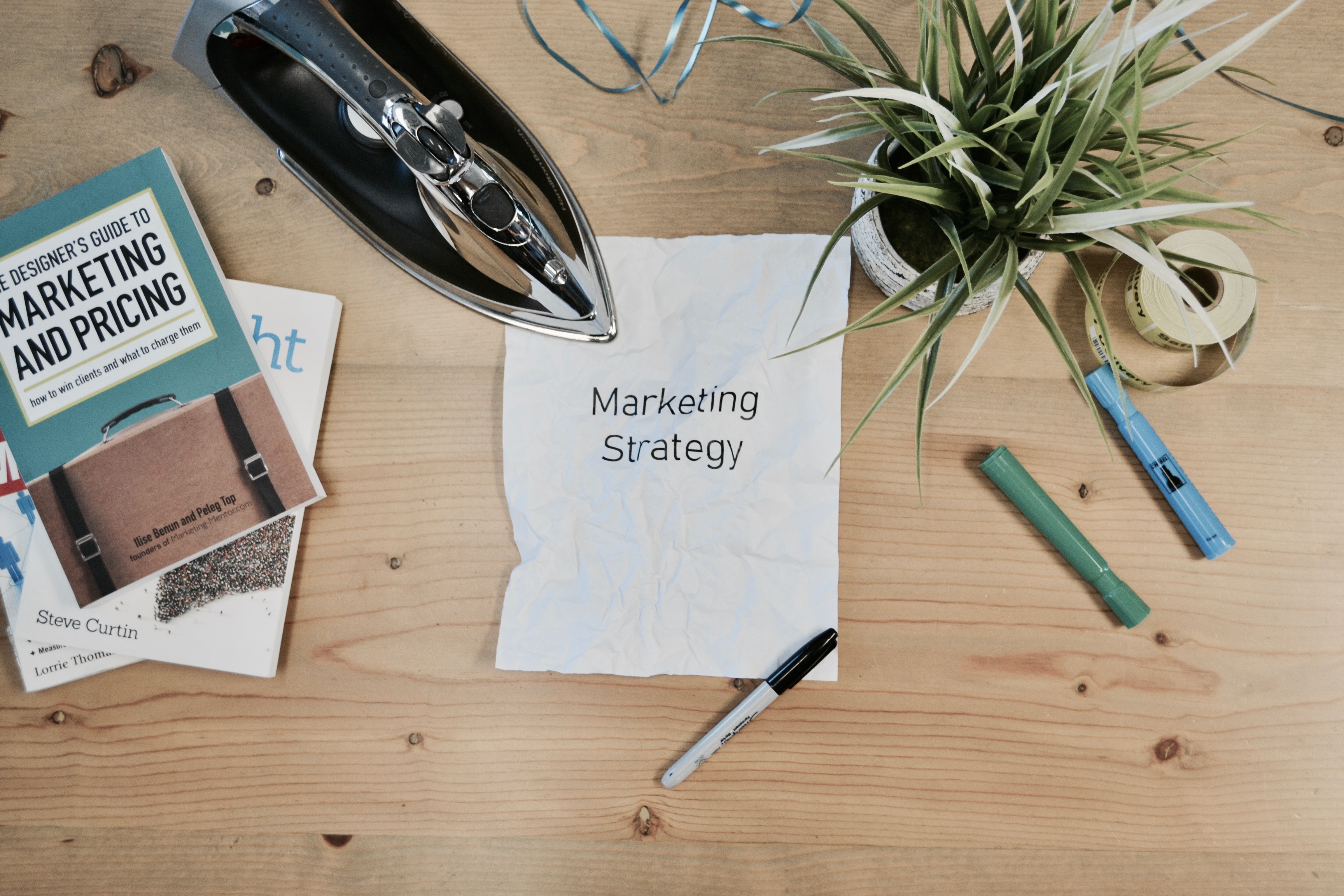 piece-of-paper-on-wooden-desk-saying-marketing-strategy