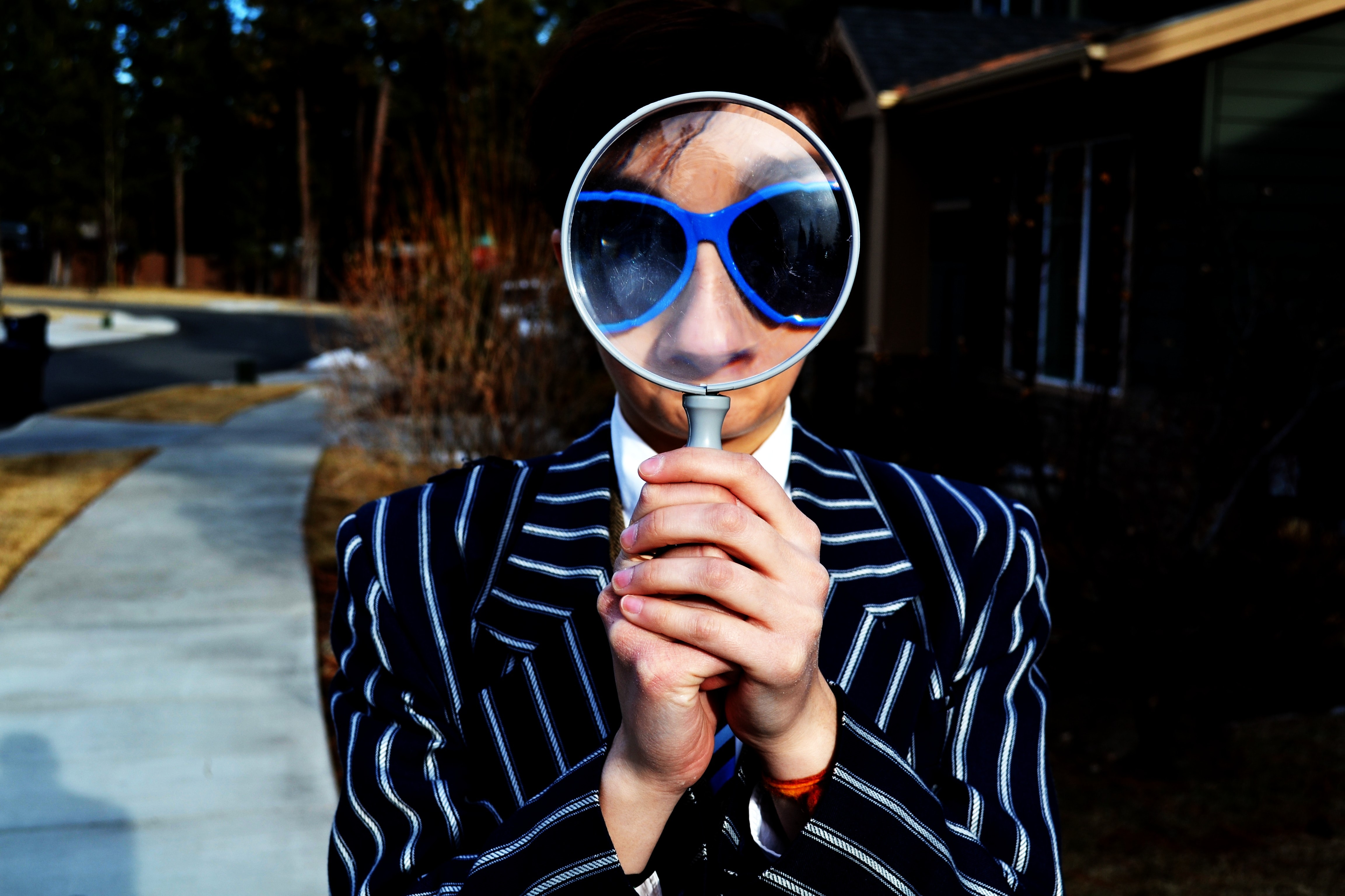person-looking-through-magnifying-glass